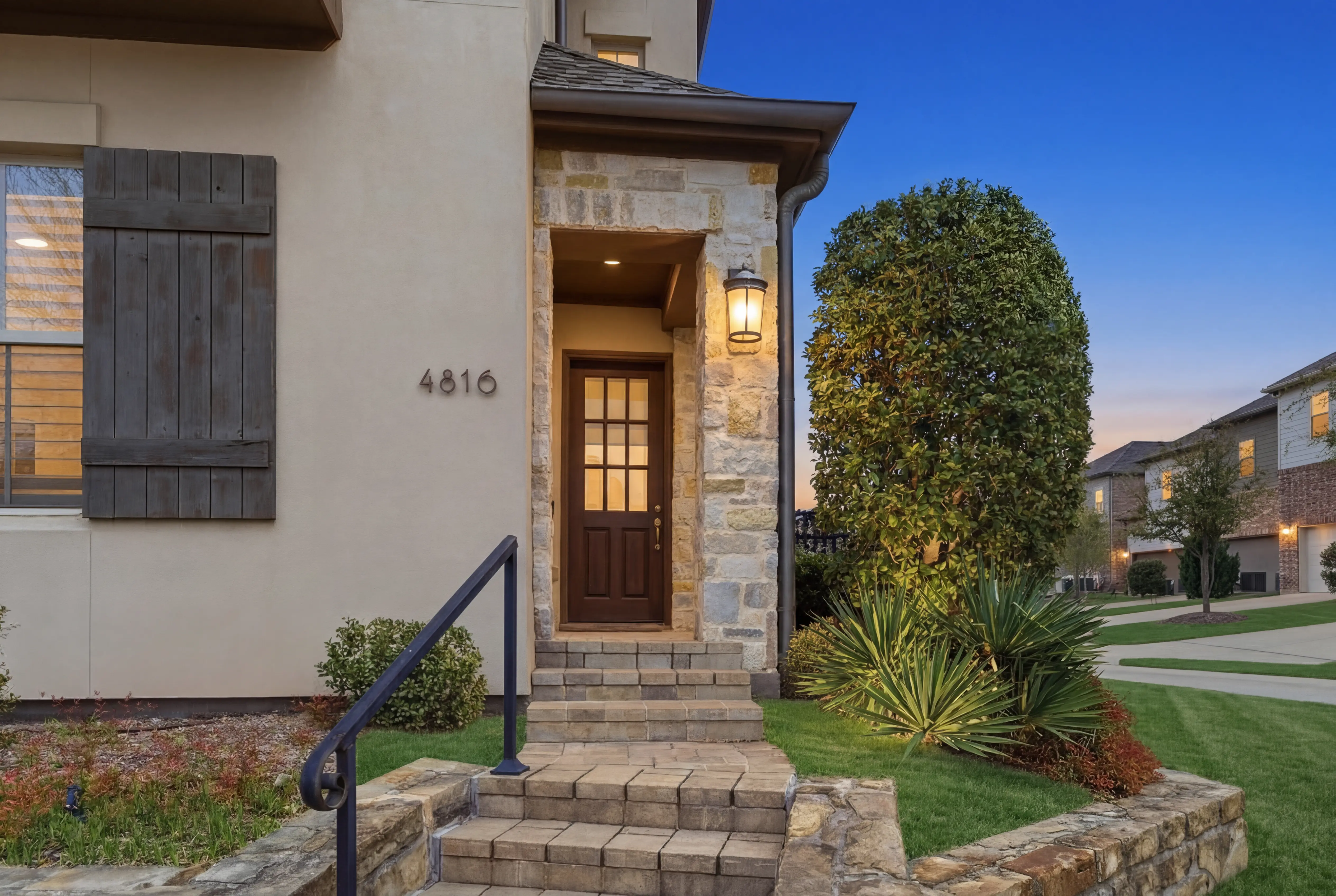 4816 Isleworth Drive - Stone entry with address number at twilight