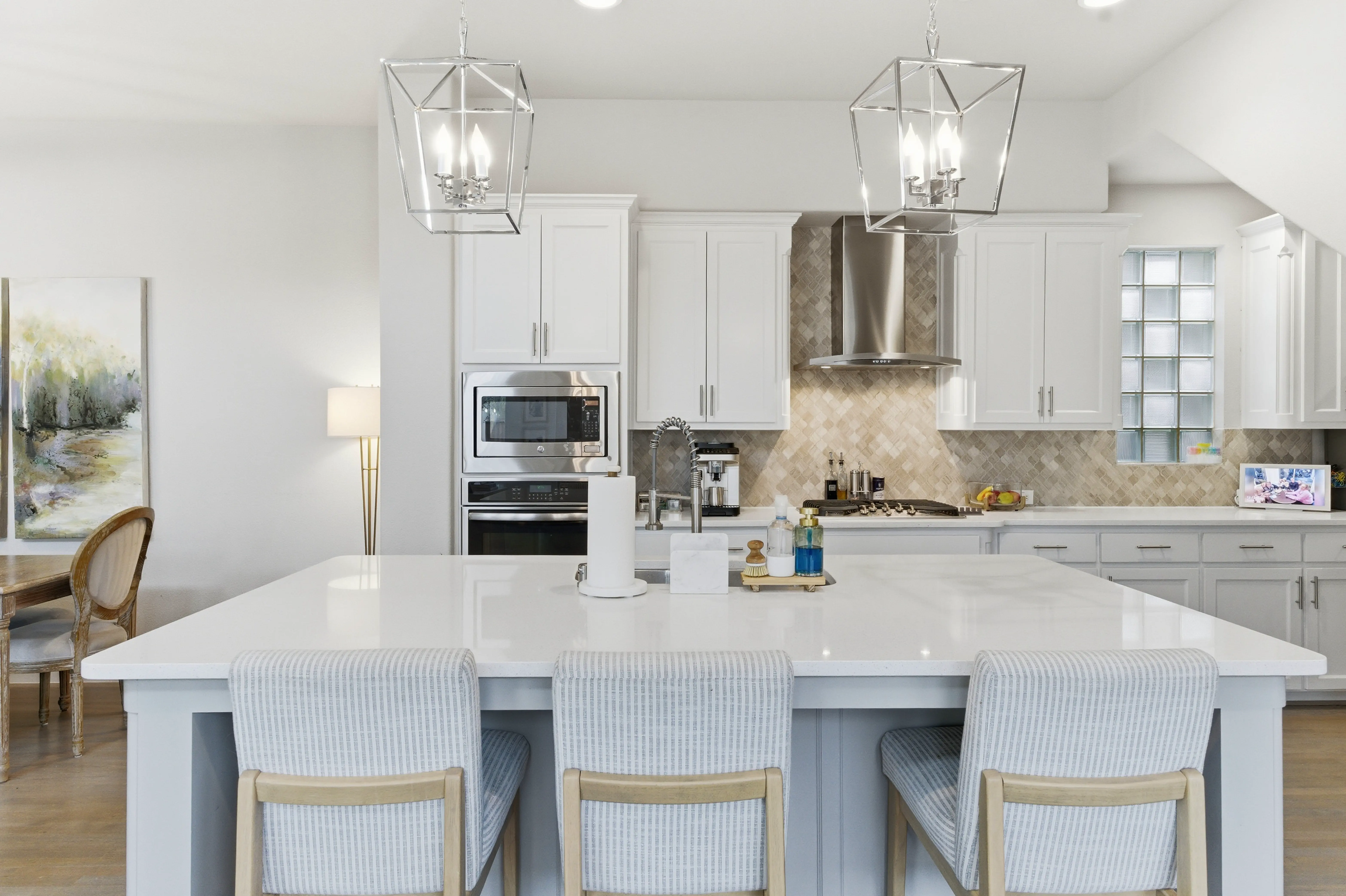 Kitchen with oversized island, bar seating, and pendant lights
