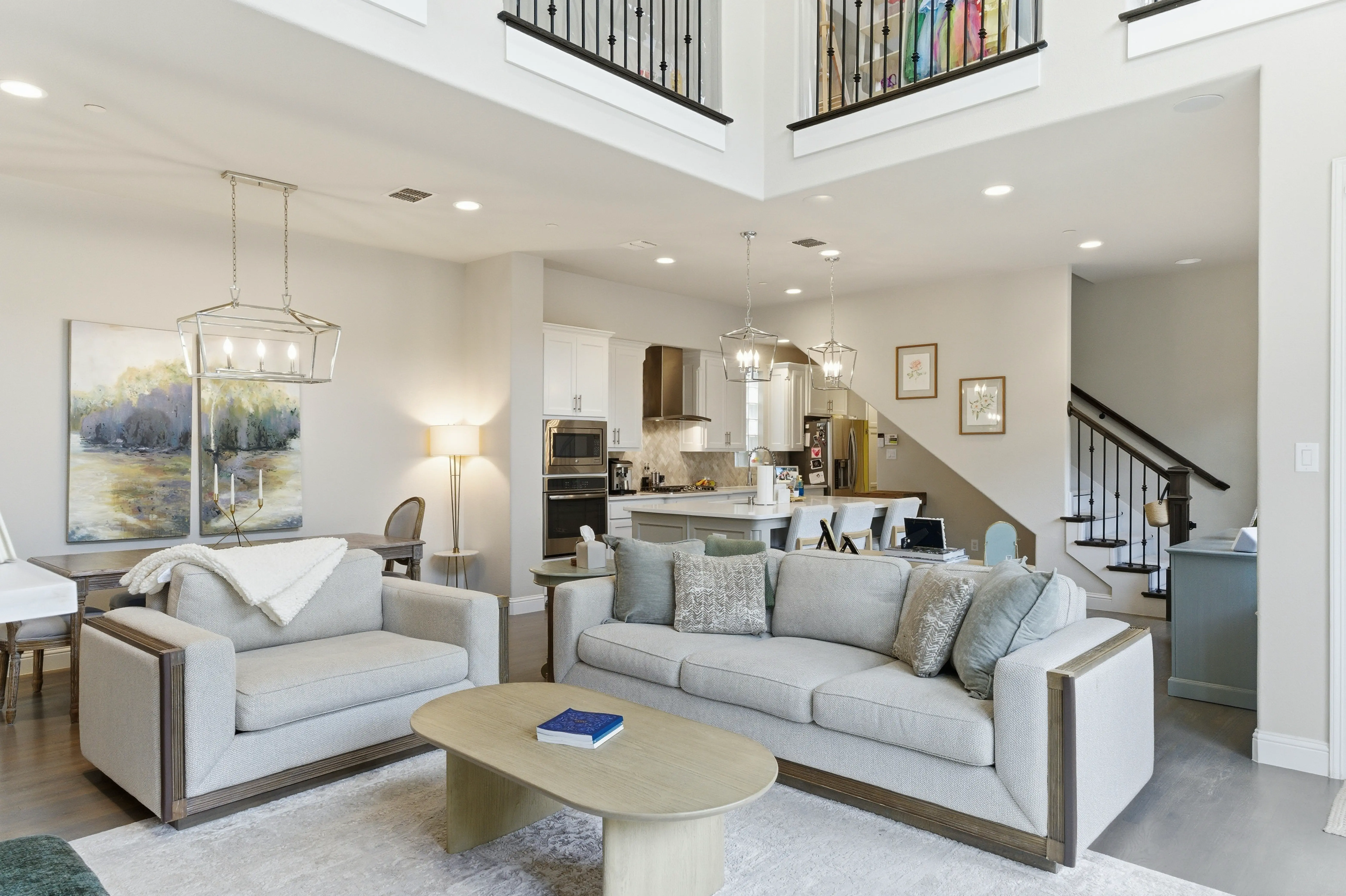 Open-concept living area with vaulted ceilings and hardwood floors