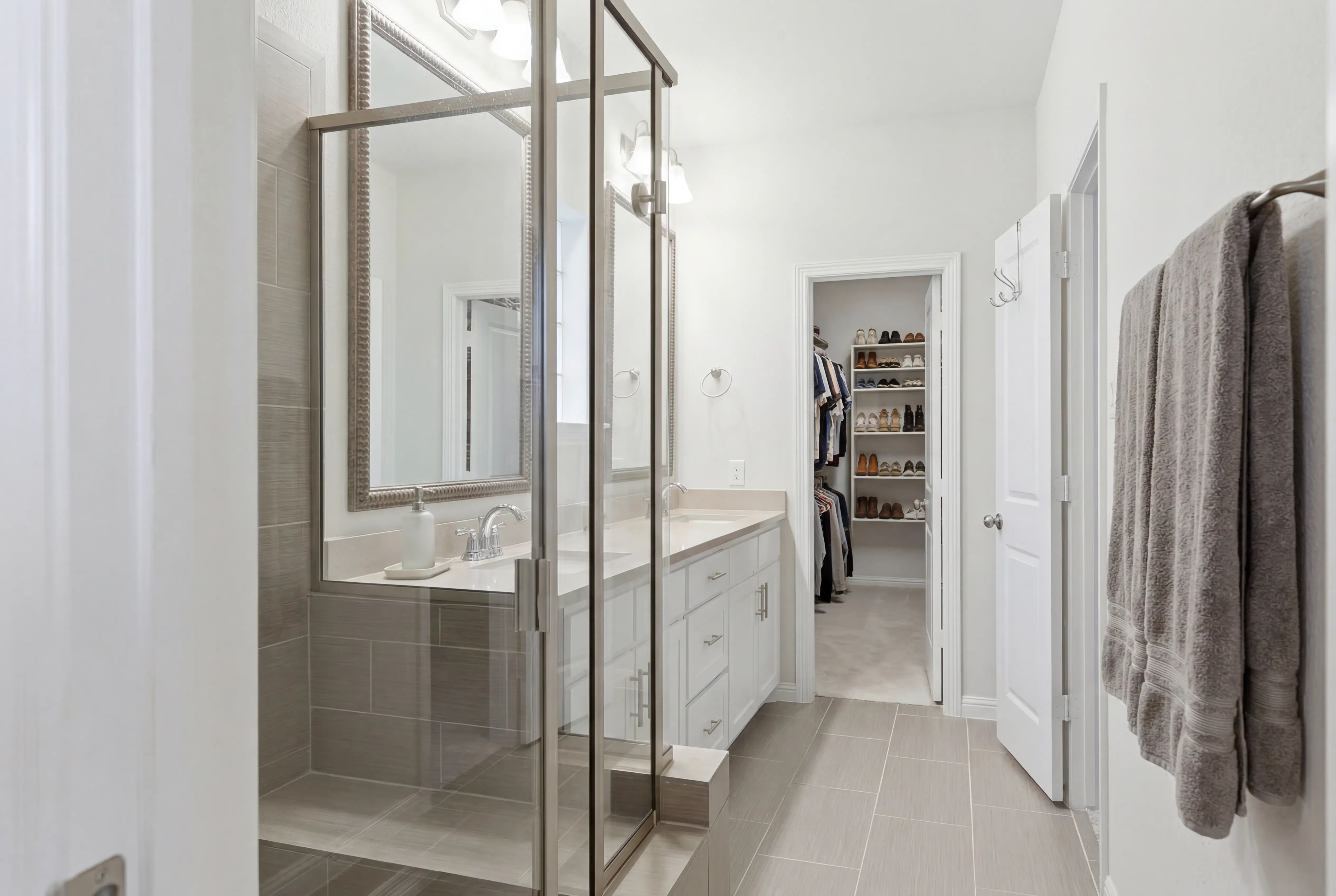 Primary bathroom with glass shower and vanity
